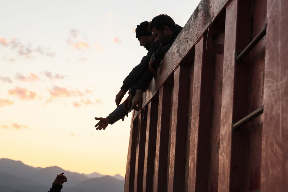 People in the back of a truck after crossing the border near Kornidzor on September 28.