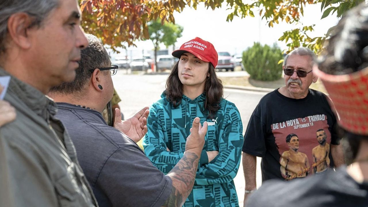 Ryan Martinez, center, stands at a rally outside a Rio Arriba County building on Thursday. Police say he later shot and wounded a man during a scuffle.