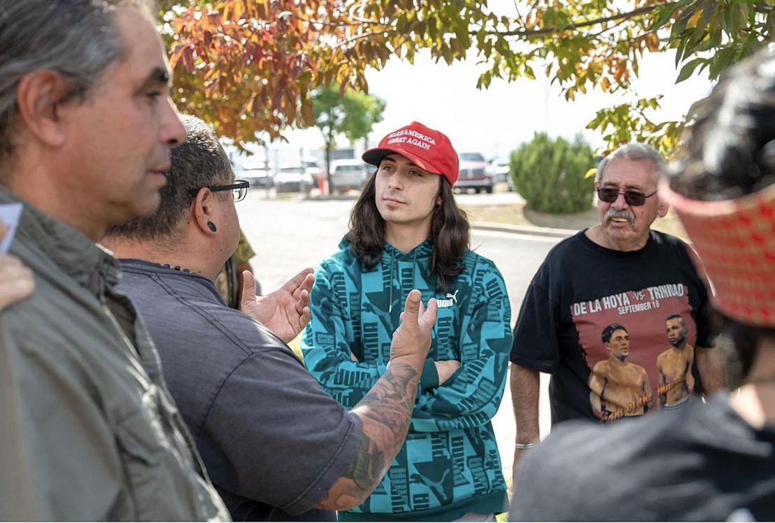 Ryan Martinez, center, stands at a rally outside a Rio Arriba County building on Thursday. Police say he later shot and wounded a man during a scuffle.