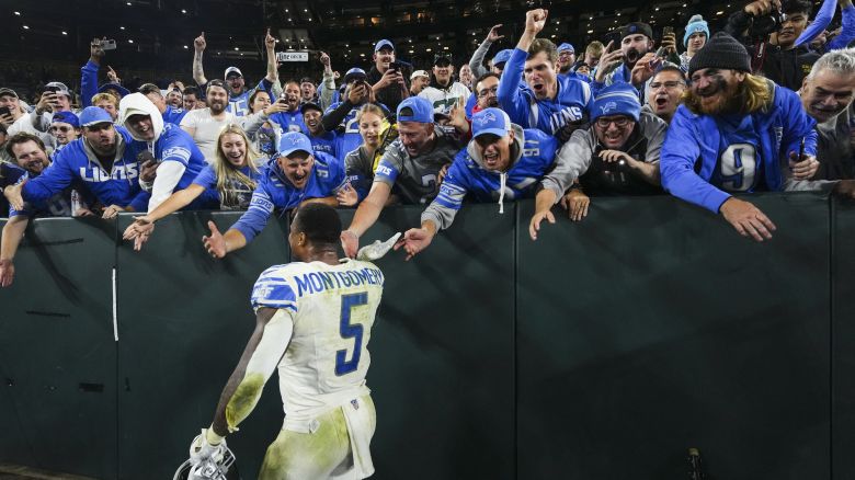GREEN BAY, WI - SEPTEMBER 28: David Montgomery #5 of the Detroit Lions celebrates with fans after an NFL football game at Lambeau Field on September 28, 2023 in Green Bay, Wisconsin. (Photo by Cooper Neill/Getty Images)
