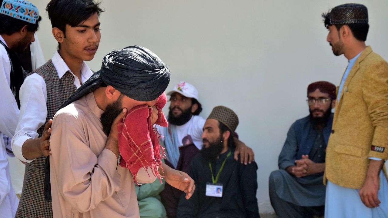 People mourn a relative who was killed in the explosion.