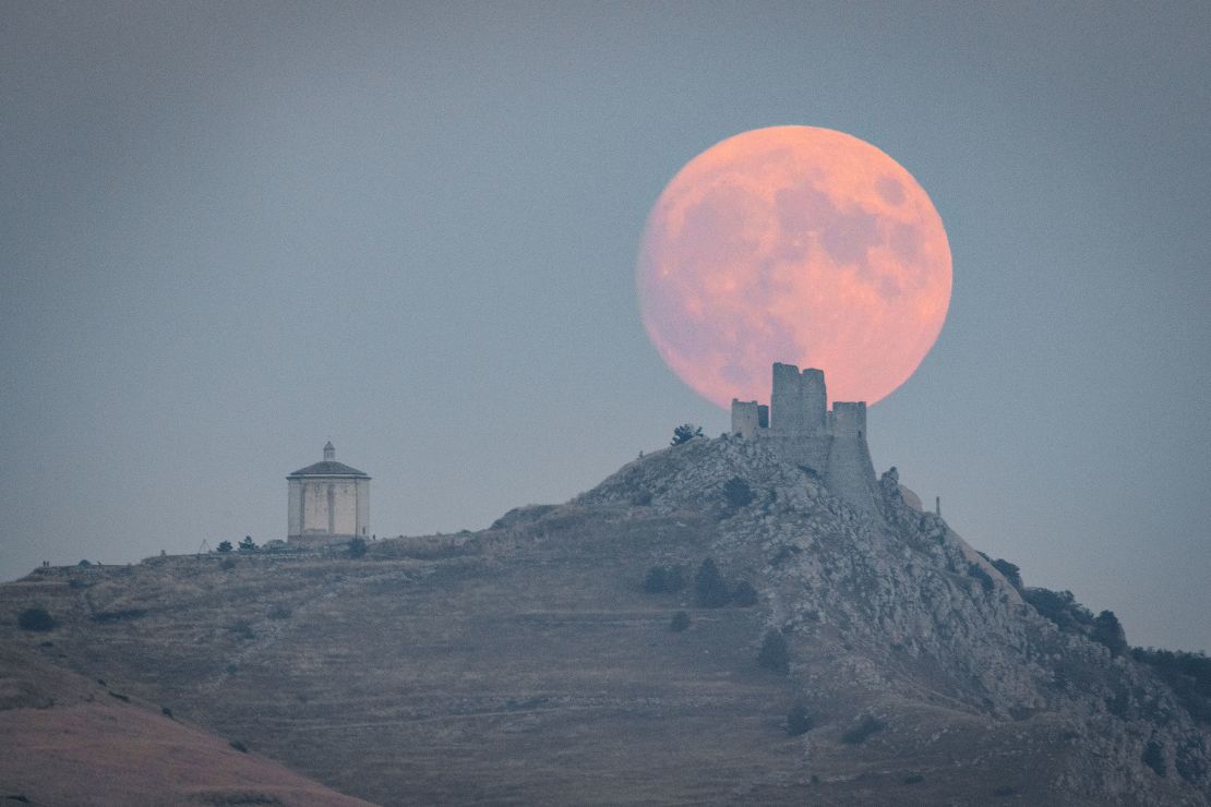 Full harvest moon rising behind Rocca Calascio castle and Santa Maria della Pietà church is seen in Calascio (L'Aquila, Abruzzo), Italy, on September 28, 2023. Harvest Moon is the full moon that occurs closest to the autumnal equinox. It is a supermoon, which means that it will appear larger and brighter than usual and is last 2023 super moon.  (Photo by Lorenzo Di Cola/NurPhoto via Getty Images)