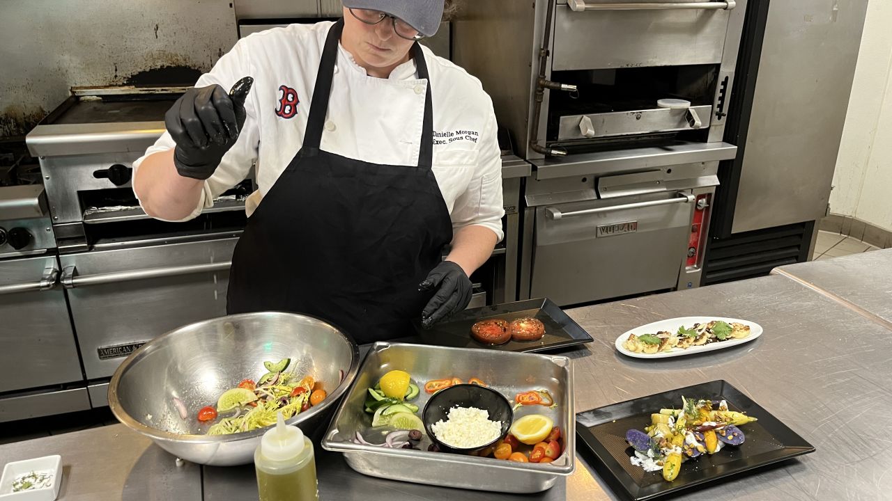 The produce grown at Fenway Farms stays as local as it gets -- used in the kitchens at the baseball stadium to serve fans. Here, executive sous chef Danielle Morgan prepares a fresh salad using ingredients harvested from the farm.