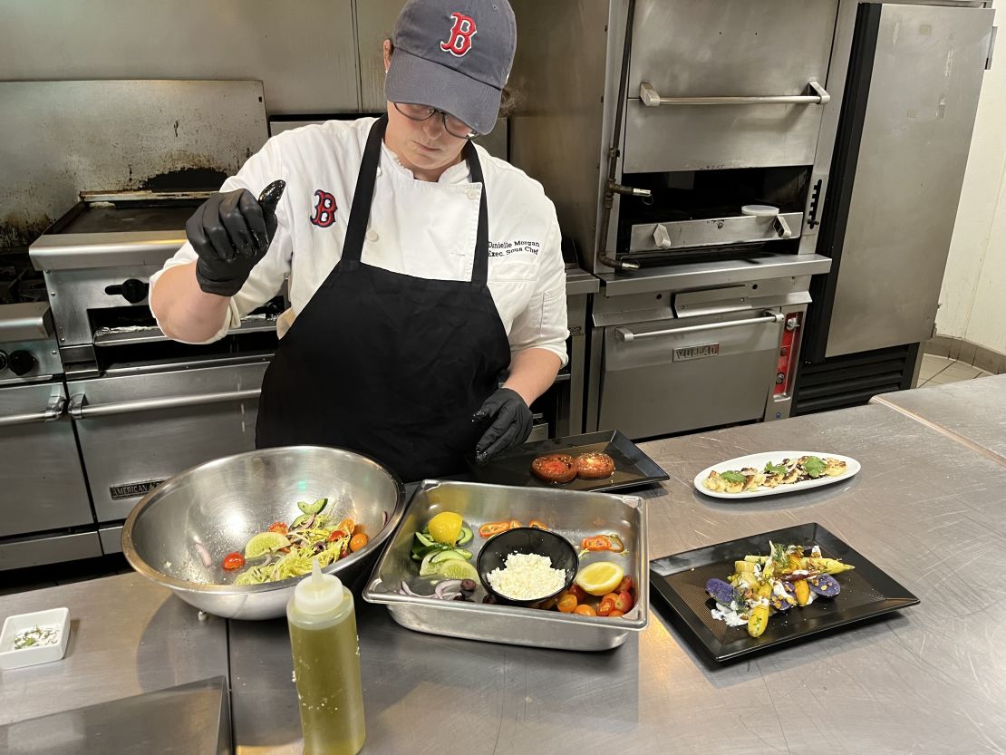 The produce grown at Fenway Farms stays as local as it gets -- used in the kitchens at the baseball stadium to serve fans. Here, executive sous chef Danielle Morgan prepares a fresh salad using ingredients harvested from the farm.
