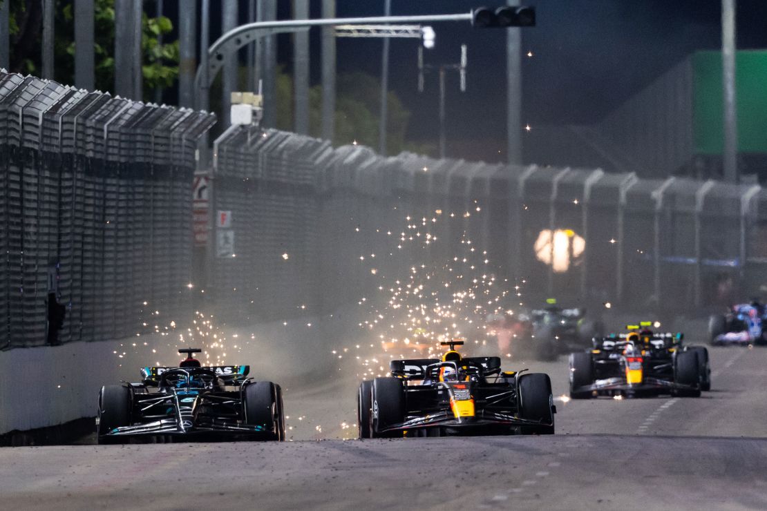 SINGAPORE, SINGAPORE - SEPTEMBER 17: George Russell of Great Britain driving the (63) Mercedes AMG Petronas F1 Team W14 and Max Verstappen of the Netherlands driving the (1) Oracle Red Bull Racing RB19 compete for position on track during the F1 Grand Prix of Singapore at Marina Bay Street Circuit on September 17, 2023 in Singapore, Singapore. (Photo by Clive Rose/Getty Images)