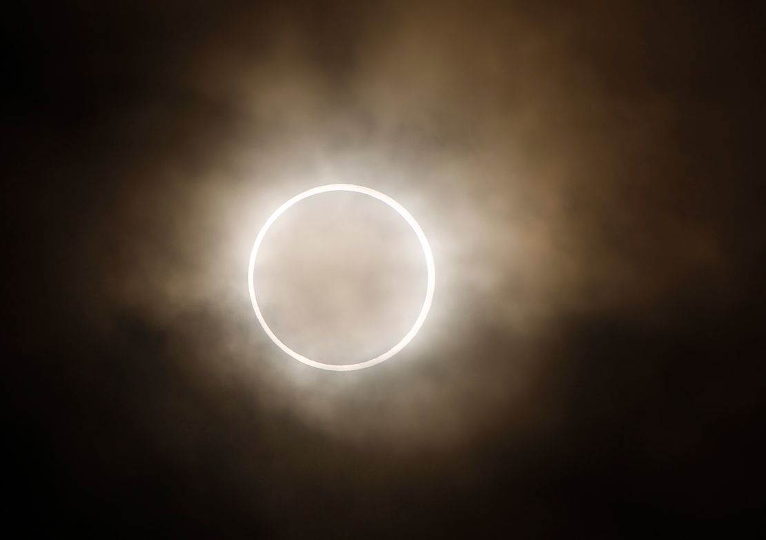 The moon slides across the sun, showing a blazing halo of light,  during an annular eclipse at a waterfront park in Yokohama, near Tokyo, Monday, May 21, 2012. Millions of Asians watched as a rare "ring of fire" eclipse crossed their skies early Monday. The annular eclipse, in which the moon passes in front of the sun leaving only a golden ring around its edges, was visible to wide areas across the continent.  (AP Photo/Shuji Kajiyama)