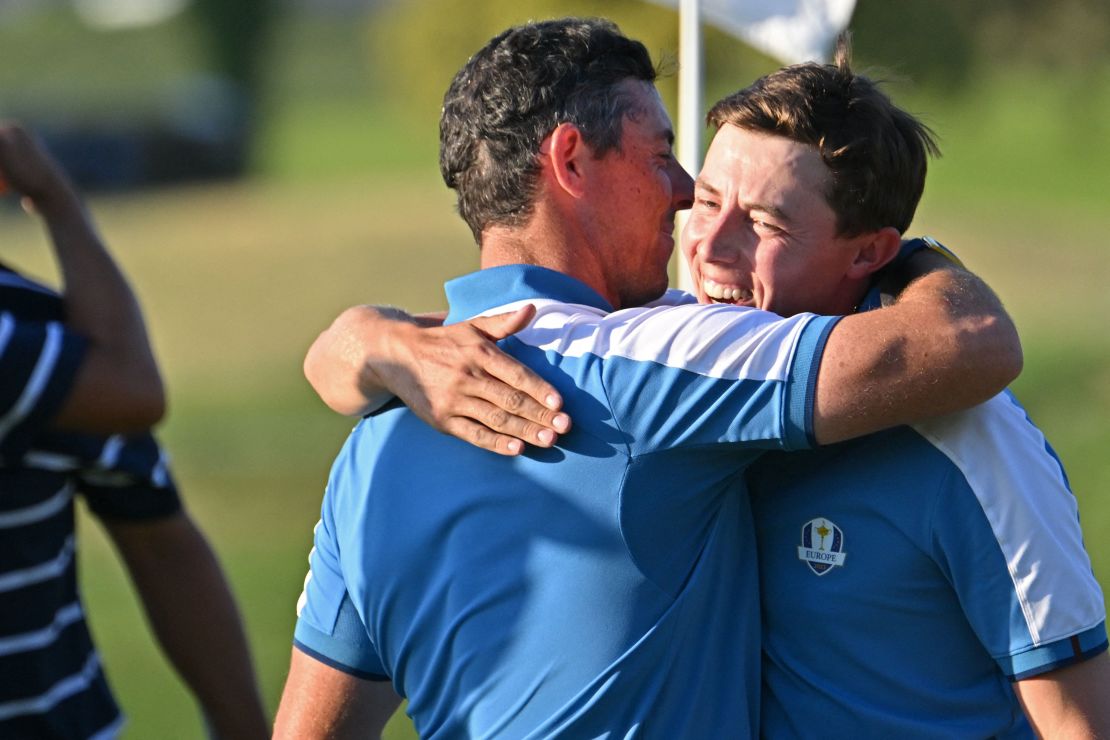 Europe's English golfer, Matt Fitzpatrick (R) and Europe's Northern Irish golfer, Rory McIlroy (L) celebrate their four-ball match win on the first day of play in the 44th Ryder Cup at the Marco Simone Golf and Country Club in Rome on September 29, 2023. (Photo by Alberto PIZZOLI / AFP) (Photo by ALBERTO PIZZOLI/AFP via Getty Images)