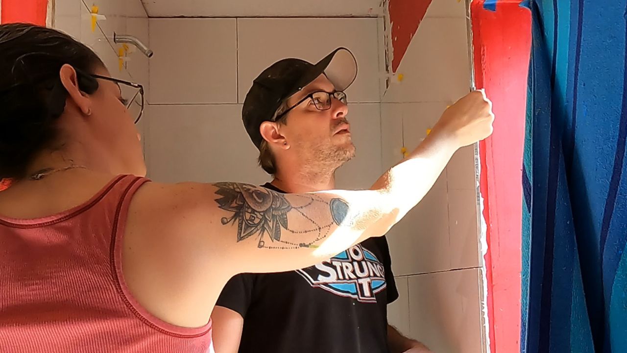 Logan Ricketts (right) and his wife remodeling the bathroom in their home in September.