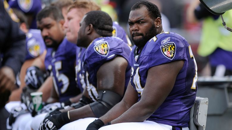 FILE - Baltimore Ravens offensive tackle Michael Oher sits on the beach during the first half of an NFL football game against the Buffalo Bills in Baltimore, Sunday, Oct. 24, 2010. A Tennessee judge said Friday, Sept. 29, 2023, that she is ending a conservatorship agreement between former NFL player Oher and a Memphis couple who took him in when he was in high school. (AP Photo/Nick Wass, File)