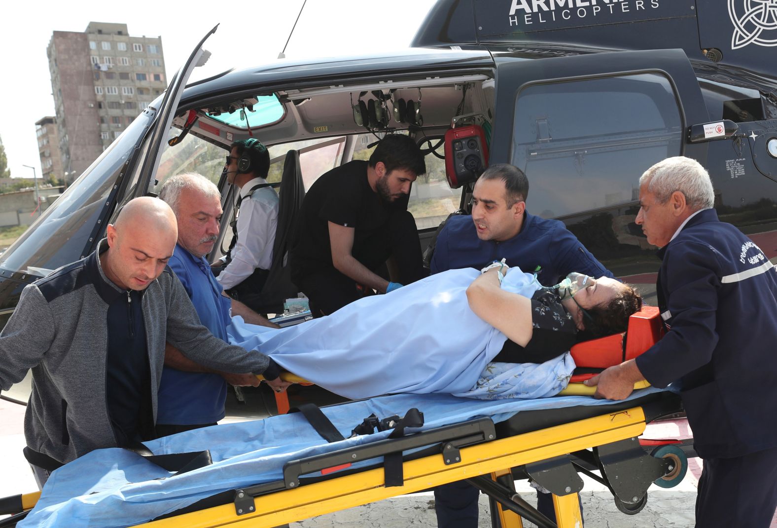 Paramedics and employees transport a sick Nagorno-Karabakh woman from Goris to the Erebuni Medical Center in Yerevan, Armenia, on September 29.