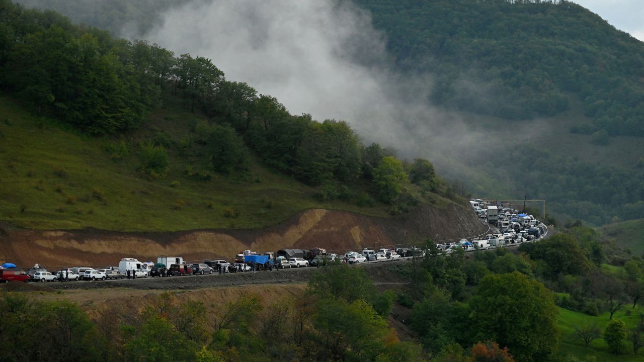 Vehicles carrying refugees from Nagorno-Karabakh head toward the Armenian border on September 25, 2023.