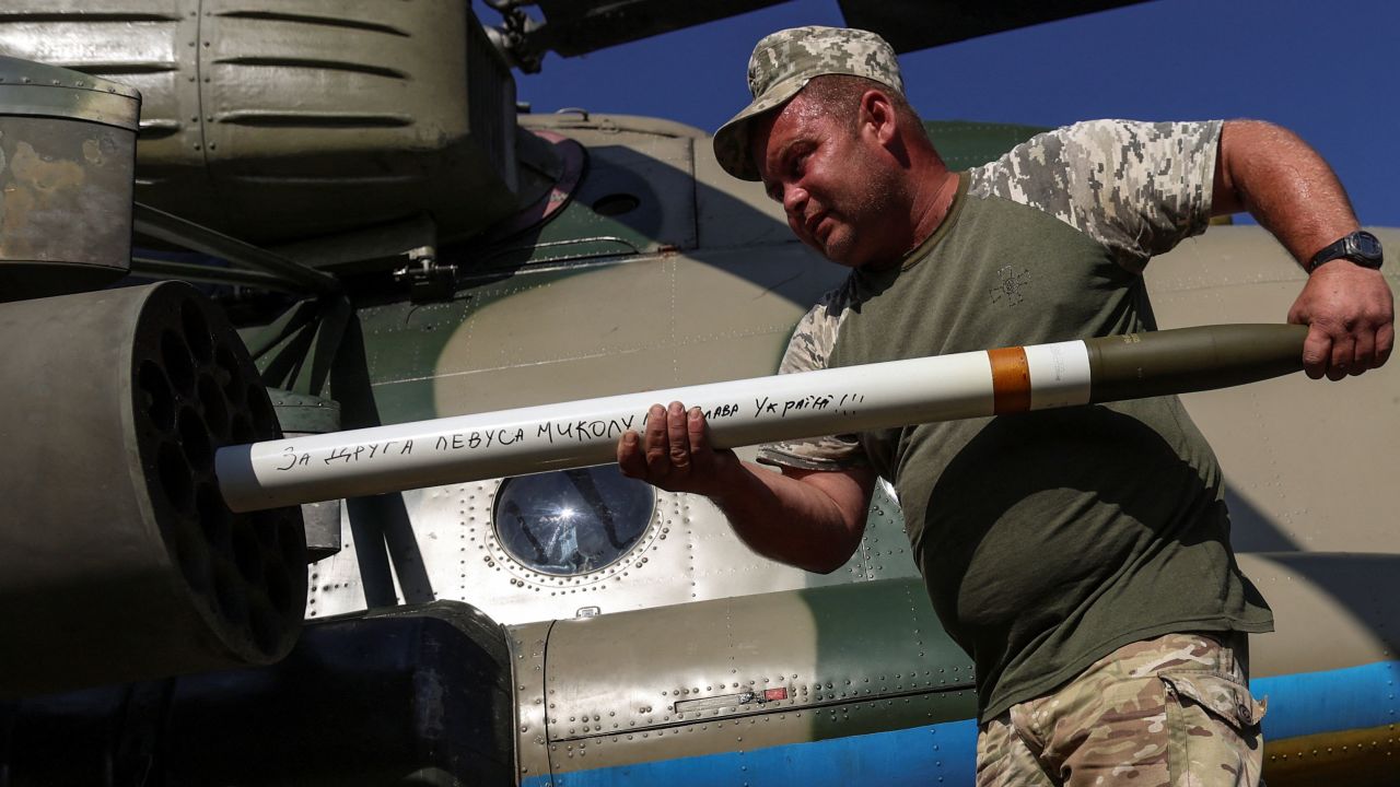 A Ukrainian serviceman loads unguided missiles into a launcher of a military Mi-8 helicopter in eastern Ukraine on Friday.