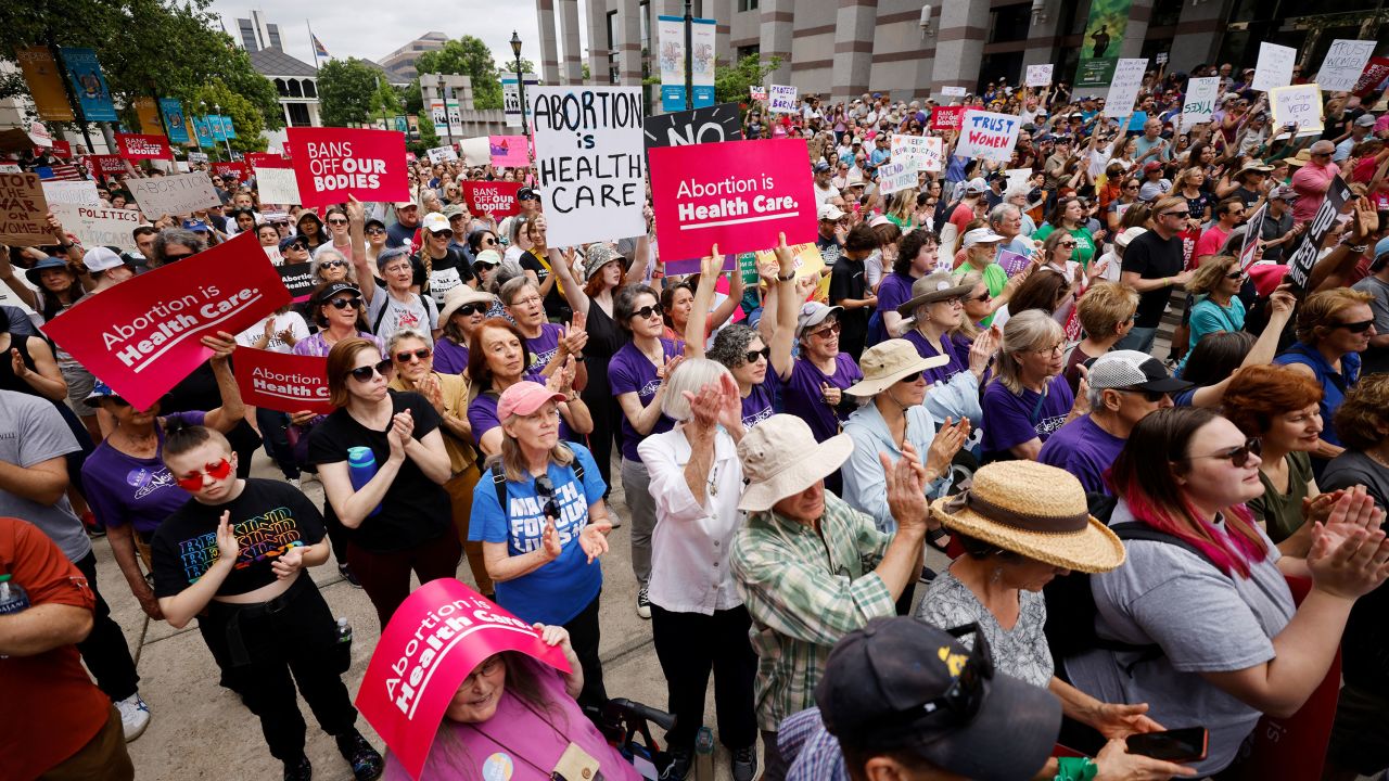 Abortion rights supporters display protest signs as they gather to witness North Carolina Governor Roy Cooper vetoing the SB 20 legislation limiting most abortions to the first trimester of pregnancy.
