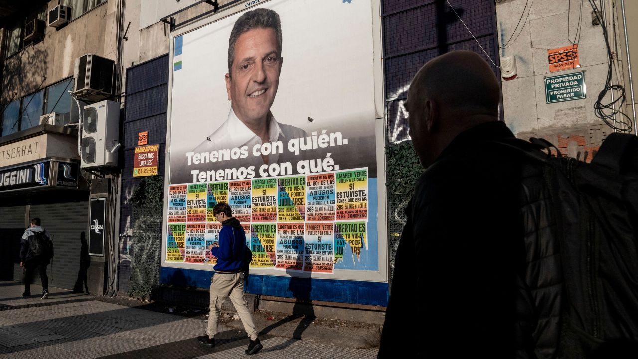 Pedestrians walk past a campaign poster for Sergio Massa, Argentina's economy minister and presidential candidate of Unity for the Homeland party in Buenos Aires on Sept. 29.