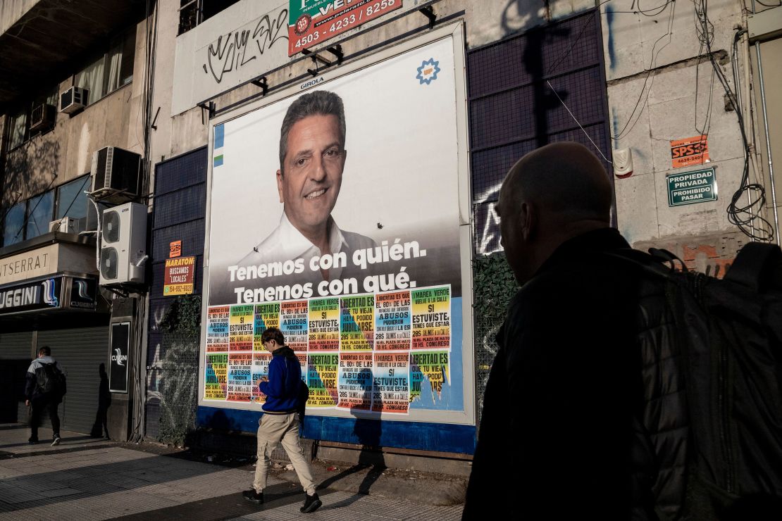 Pedestrians walk past a campaign poster for Sergio Massa, Argentina's economy minister and presidential candidate of Unity for the Homeland party in Buenos Aires on Sept. 29.