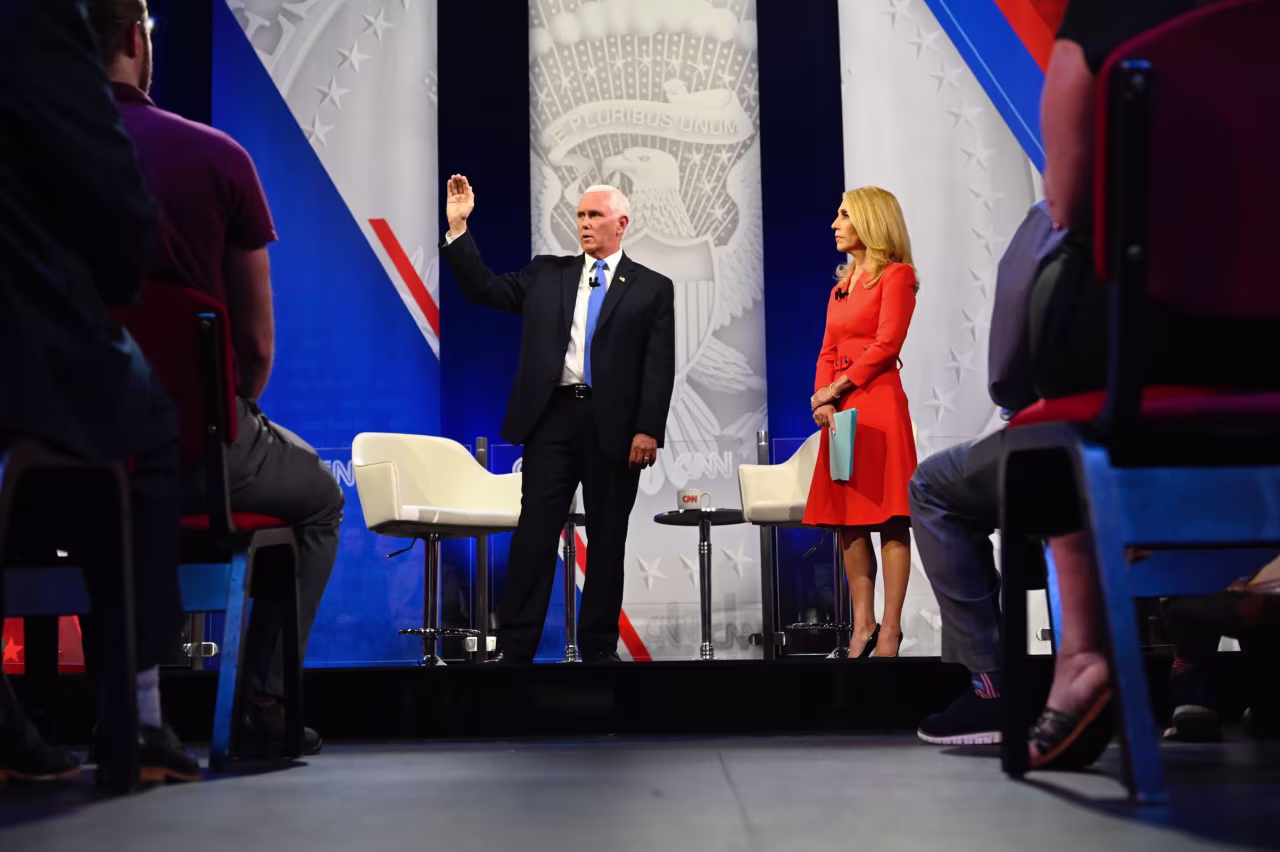 Mike Pence gestures while answering a question while on stage with CNN's Dana Bash.