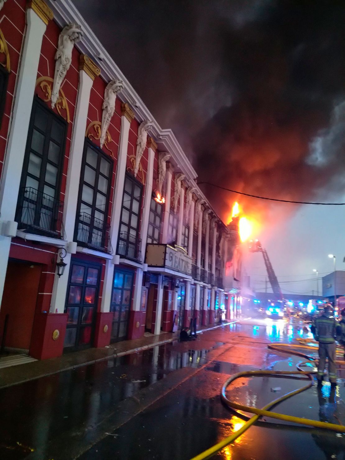Emergency services work to extinguish the fire on Sunday, where at least 13 people were killed.