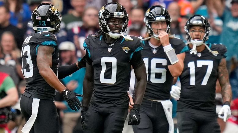 Jacksonville Jaguars wide receiver Calvin Ridley (0), second left, celebrates after scoring a touchdown during the first quarter of an NFL football game between the Atlanta Falcons and the Jacksonville Jaguars at Wembley stadium in London, Sunday, Oct. 1, 2023. (AP Photo/Kirsty Wigglesworth)