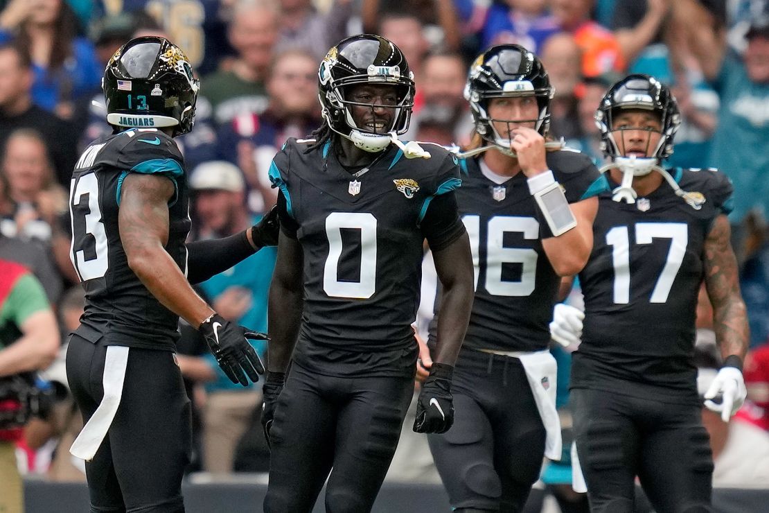 Jacksonville Jaguars wide receiver Calvin Ridley (0), second left, celebrates after scoring a touchdown during the first quarter of an NFL football game between the Atlanta Falcons and the Jacksonville Jaguars at Wembley stadium in London, Sunday, Oct. 1, 2023. (AP Photo/Kirsty Wigglesworth)