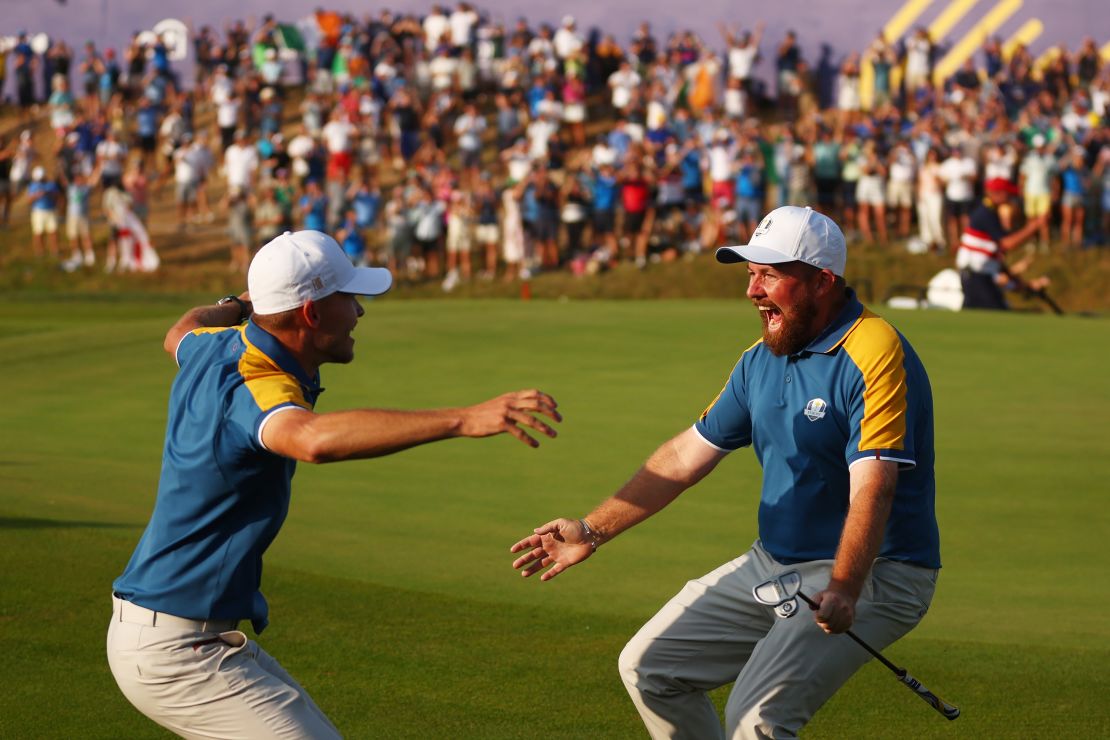 Shane Lowry of Team Europe embraces teammate Nicolai Hojgaard on the 17th green during the Sunday singles matches of the 2023 Ryder Cup at Marco Simone Golf Club on October 01, 2023 in Rome, Italy.