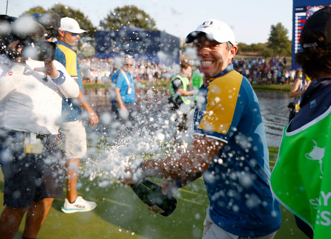 Golf - The 2023 Ryder Cup - Marco Simone Golf & Country Club, Rome, Italy - October 1, 2023
Team Europe's Rory McIlroy celebrates with sparkling wine on the 18th green after winning the Ryder Cup