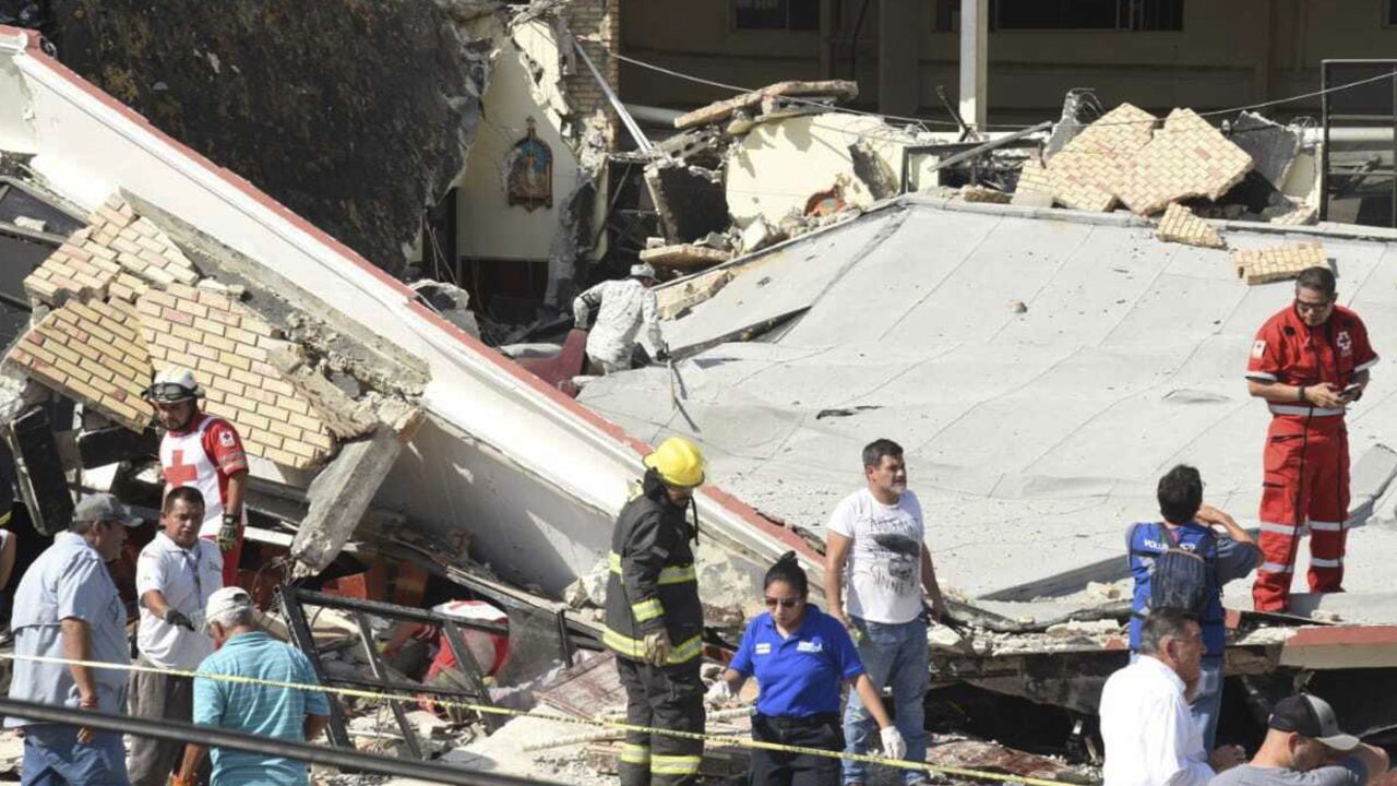 Rescue workers search in the debris for dozens of worshipers missing following the disaster. 