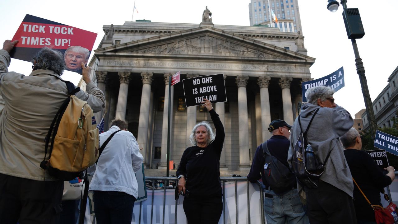 Demonstrators stand outside the New York Supreme Court on Monday, October 2, before the start of a <a href="http://www.cnn.com/2023/10/02/politics/gallery/trump-fraud-trial/index.html" target="_blank">civil fraud trial</a> in which former President Donald Trump is a co-defendant.