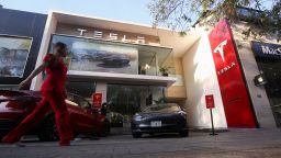 A woman walks by a Tesla dealership in Mexico City, Mexico, March 3, 2023.