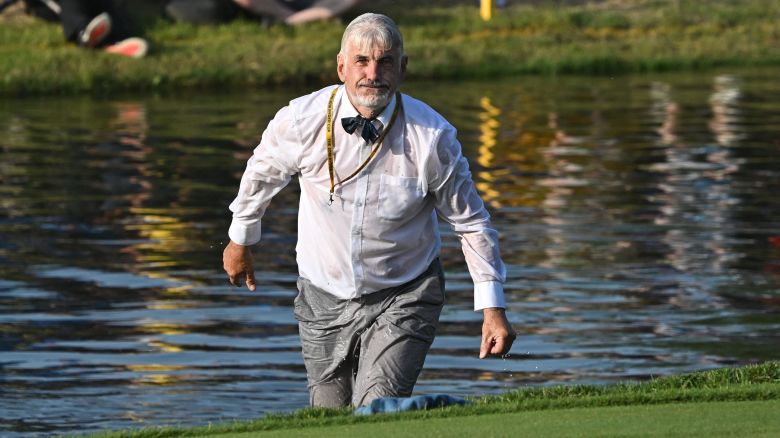 A spectator takes a dip in the lake beside the 16th green on the final day of play in the 44th Ryder Cup at the Marco Simone Golf and Country Club in Rome on October 1, 2023. (Photo by Paul ELLIS / AFP) (Photo by PAUL ELLIS/AFP via Getty Images)