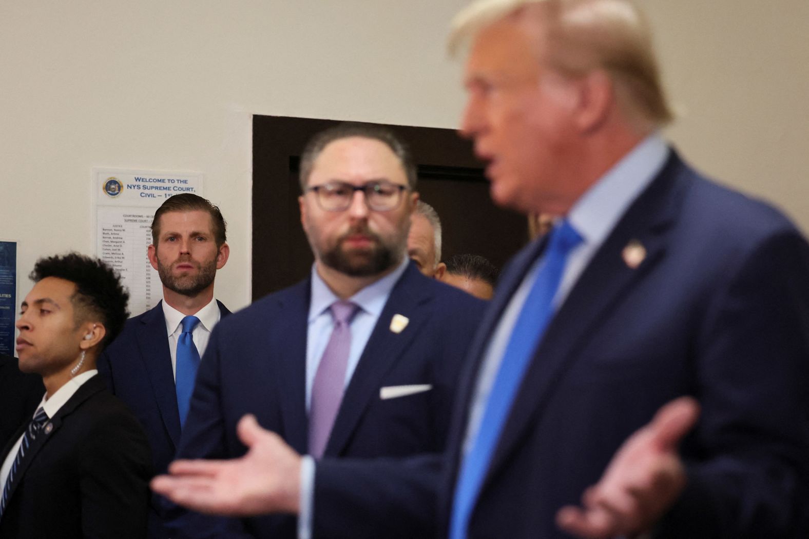 Trump's son Eric watches his father speak after arriving to the courthouse on October 2.