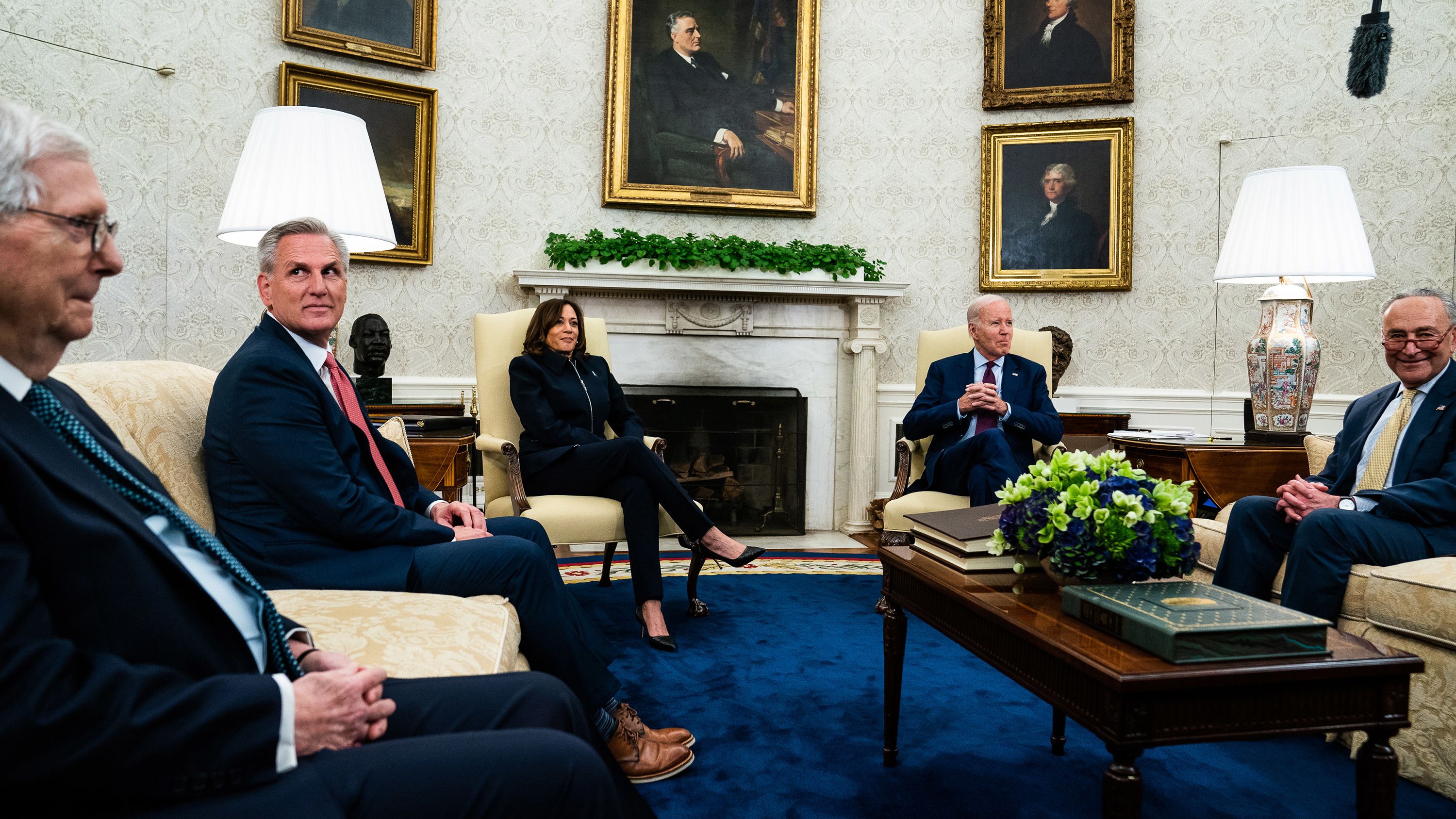 McCarthy, second from left, joins other congressional leaders as <a href="https://www.cnn.com/2023/05/16/politics/biden-kevin-mccarthy-debt-default-negotiations/index.html" target="_blank">they meet with Biden and Harris</a> in the White House Oval Office in May 2023. They were meeting to talk about a deal to raise the nation's borrowing limit and avoid a historic default.