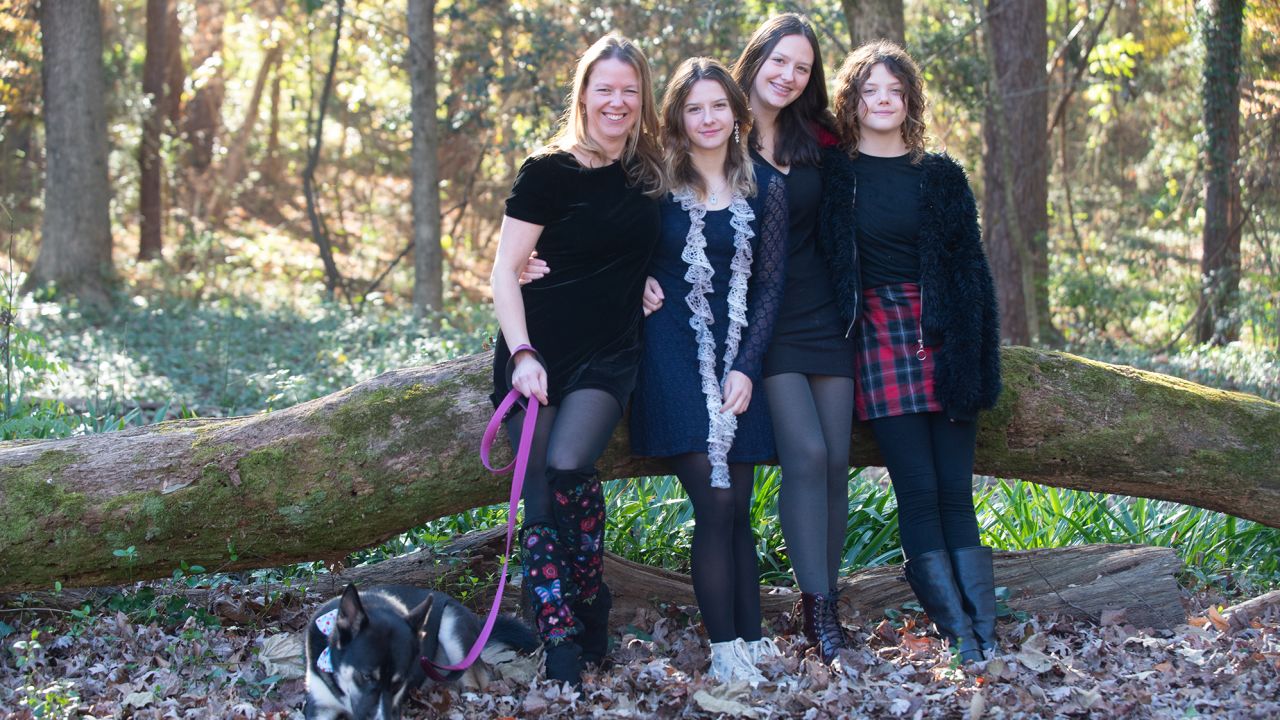 Justine Lyons (left) with her three daughters and their pup.