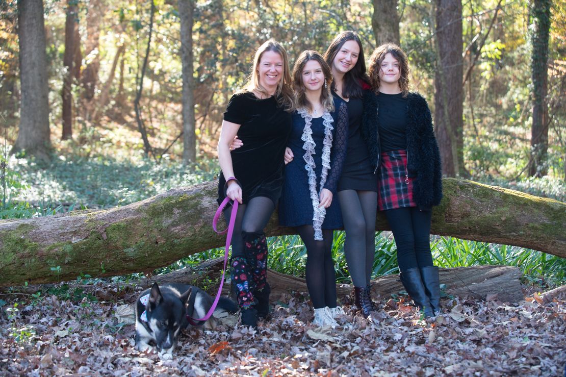 Justine Lyons (left) with her three daughters and their pup.