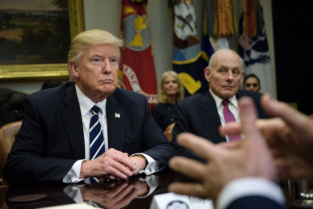 US President Donald Trump and Secretary of Homeland Security John Kelly (R) listen while Rudy Giuliani speaks a meeting on cyber security in the Roosevelt Room of the White House January 31, 2017 in Washington, DC. / AFP / Brendan Smialowski        (Photo credit should read BRENDAN SMIALOWSKI/AFP via Getty Images)