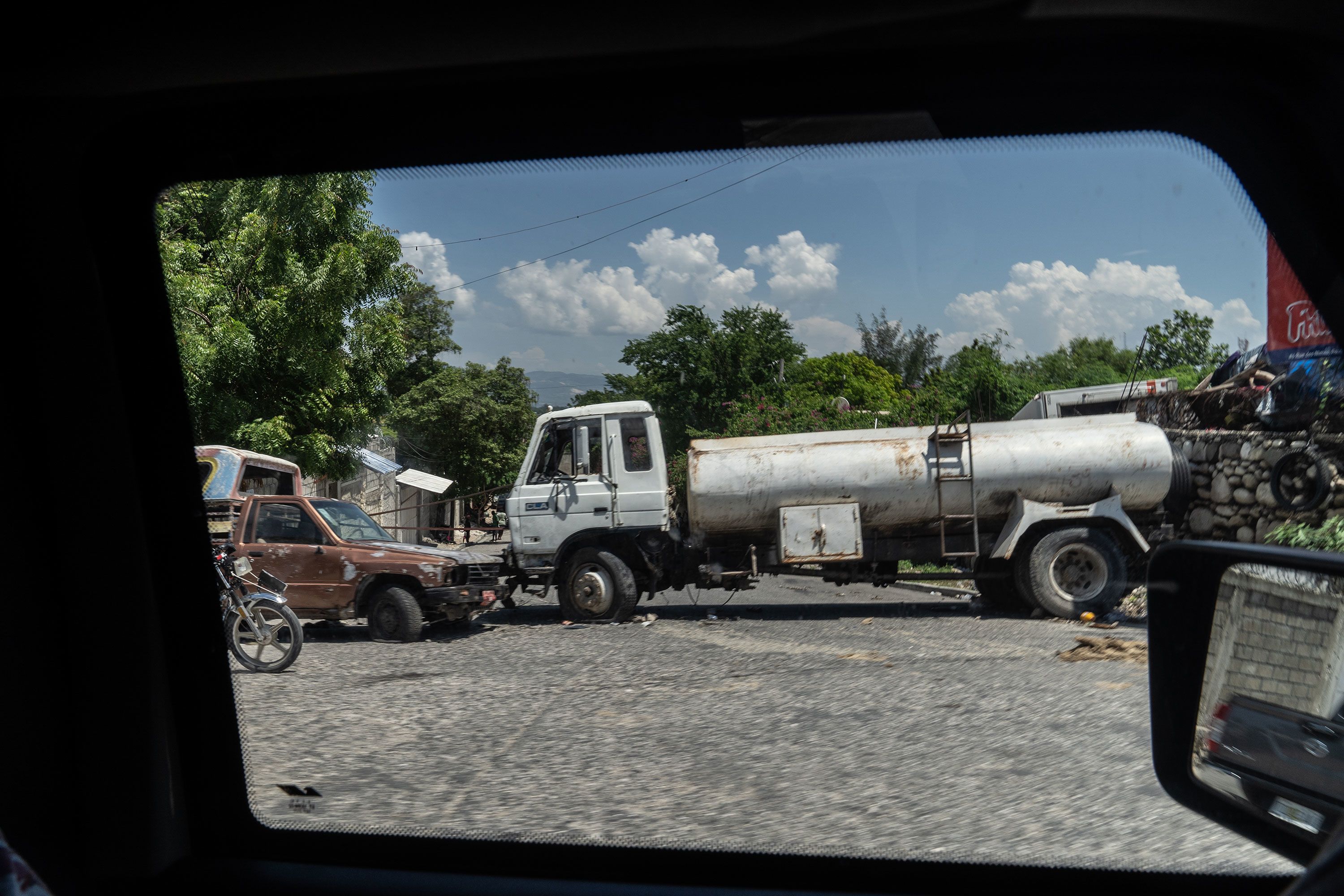 Abandoned vehicles serve as barricades in Port-au-Prince.