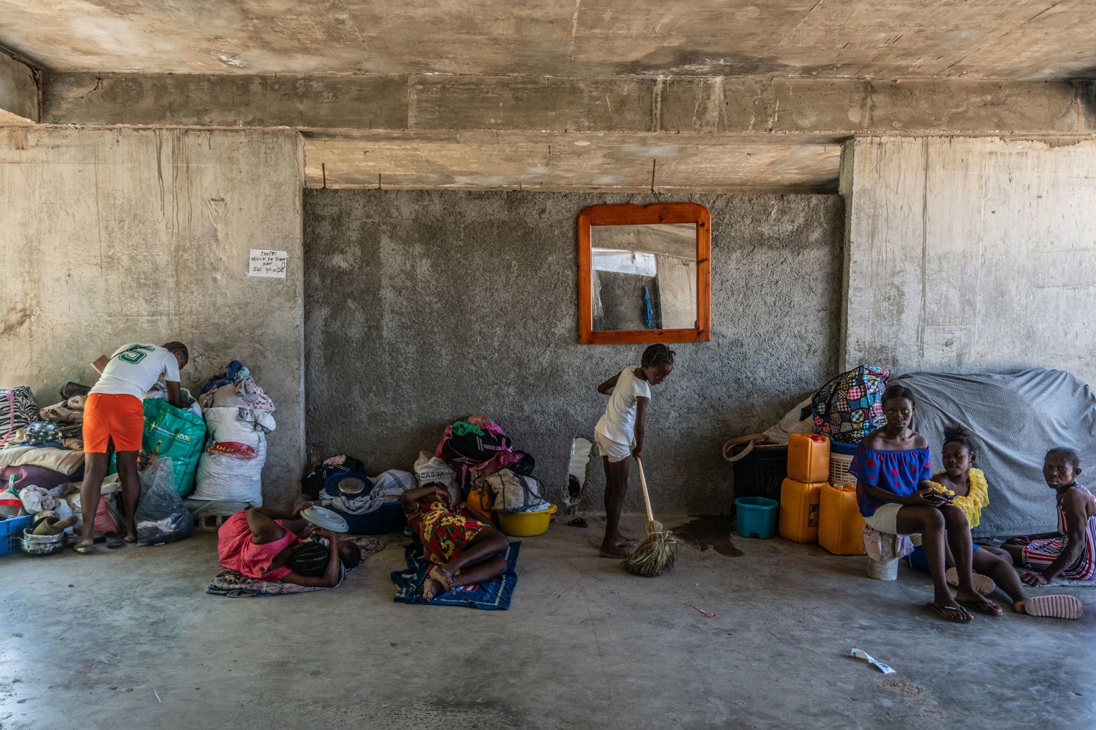 A family, driven from their home just hours earlier, set up shelter at an abandoned school in Port-au-Prince.