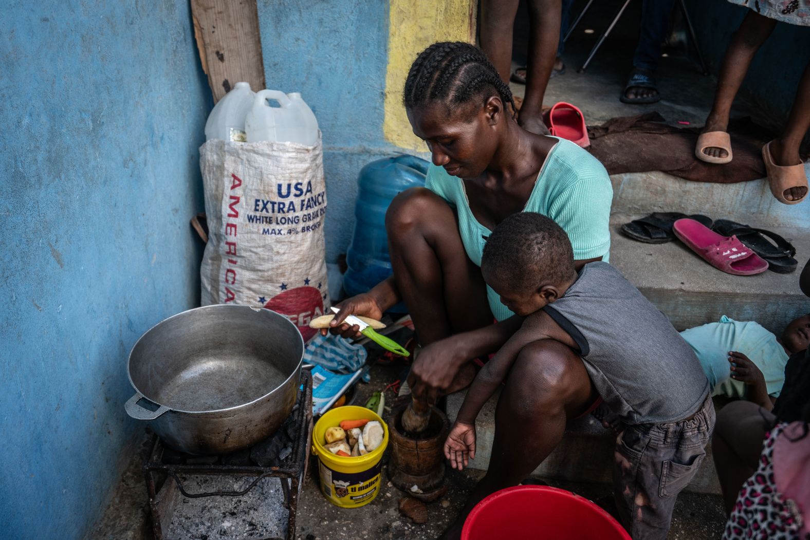A woman and her daughter prepare a meal at a shelter in Port-au-Prince.