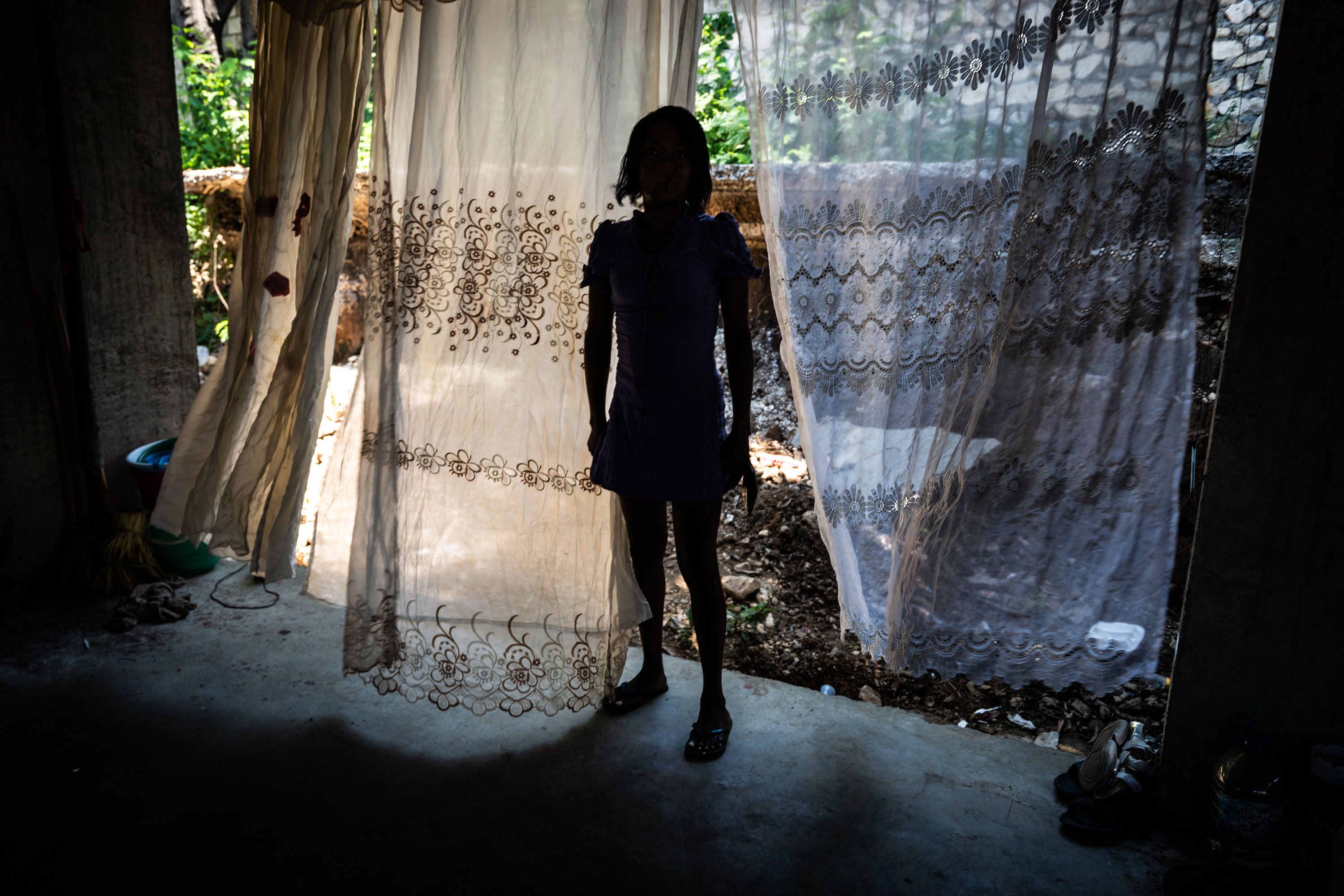 A woman resides with other family members at an abandoned building in the Delmas 4 area of Port-au-Prince.