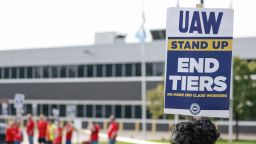 UAW members and workers hold signs outside the Ford's Chicago Assembly Plant after walking off their jobs in Chicago, Illinois, on September 29, 2023. Another 7,000 members of the biggest US automobile workers' union on Friday joined an already major strike against the top three Detroit car manufacturers. 