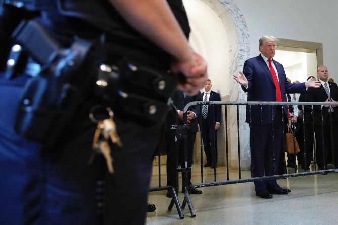 Trump speaks to the media as he arrives to court on October 3.