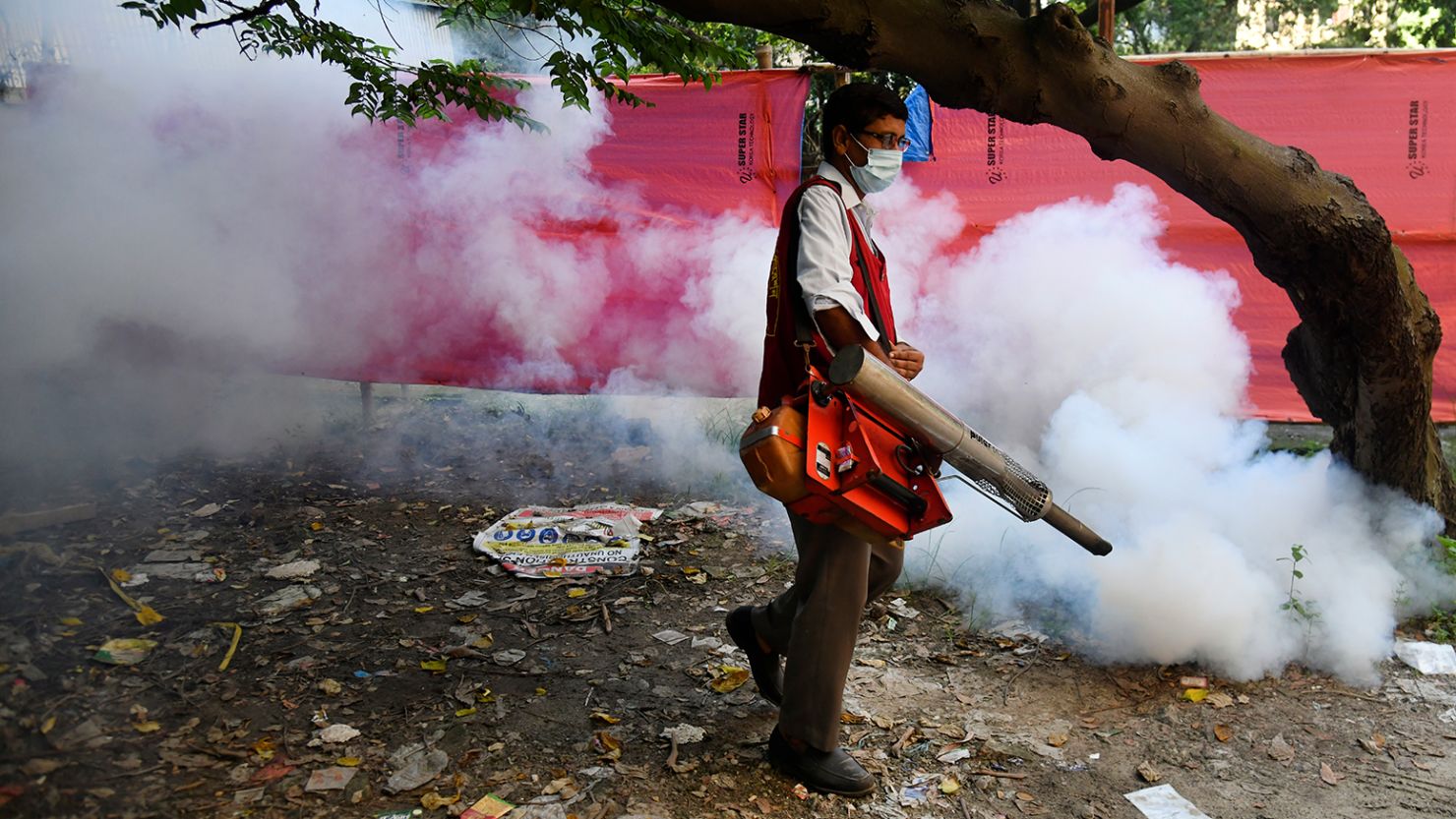 A worker sprays mosquito repellent outside a hospital in Dhaka, Bangladesh, on September 9.