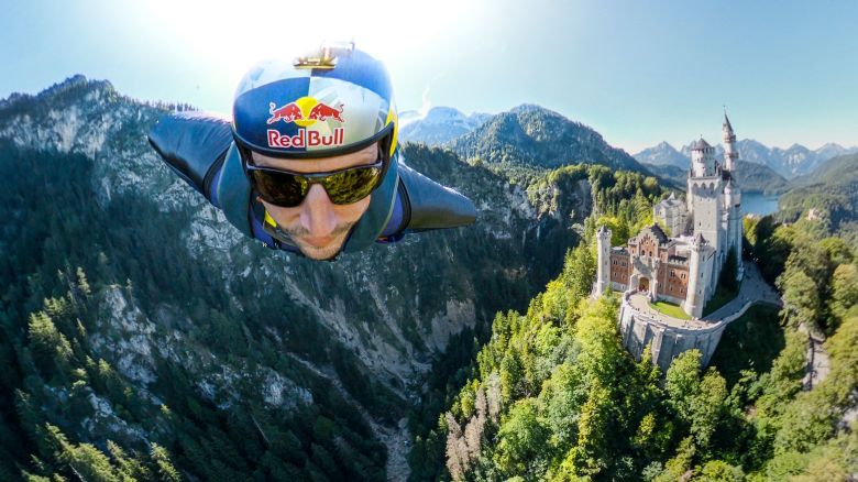Renowned German B.A.S.E. jumper and skydiver, Max Manow, embarked on an exhilarating flight beside Neuschwanstein Castle in Germany. Using a specialised wingsuit system, he captured a unique view of the iconic Bavarian landmark. Starting from the Tegelberg cable car station in Schwangau, Manow made the most of favorable weather and launched his paraglider at 5,465 feet, covering a distance of about 2.5 kilometers. // Max Manow of Germany seen in front of the Neuschwanstein Castle in Schwangau, Bavaria, Germany on September 20, 2023 // Sebastian Marko / Red Bull Content Pool via AP Images  // For more content, pictures and videos like this please go to http://www.redbullcontentpool.com