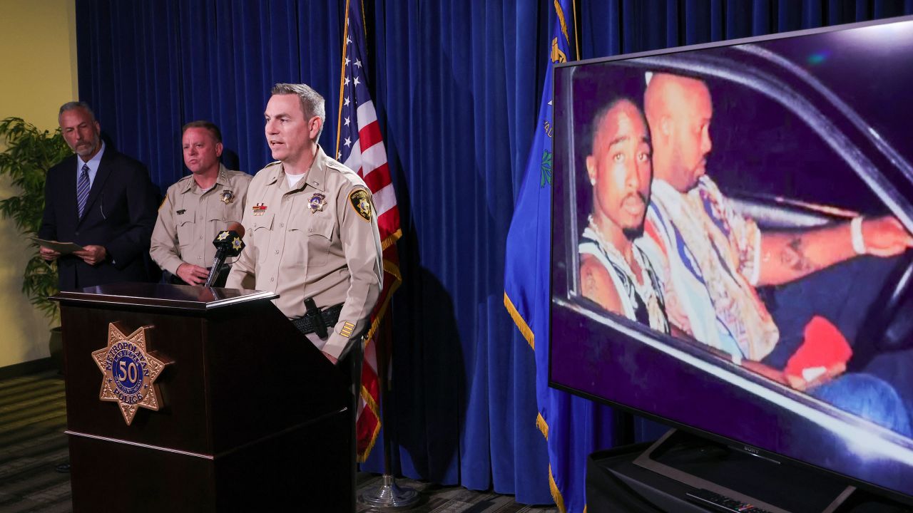 An image on a TV monitor shows a photo of Tupac Shakur, left, and Marion "Suge" Knight Jr. in a car in Las Vegas the night Shakur was killed as Las Vegas officials hold a news conference Friday about the arrest of a suspect in the case.