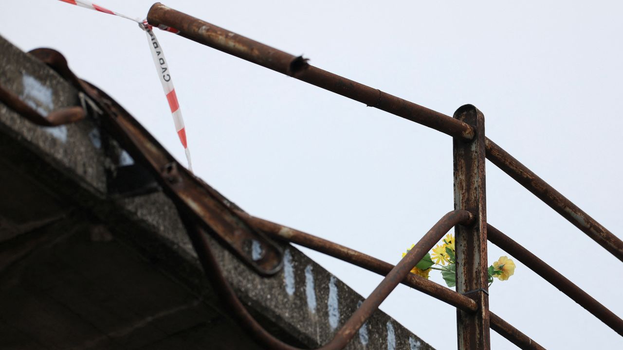 Flowers are seen on Wednesday at the site where a coach crashed off an overpass in Mestre, Italy.