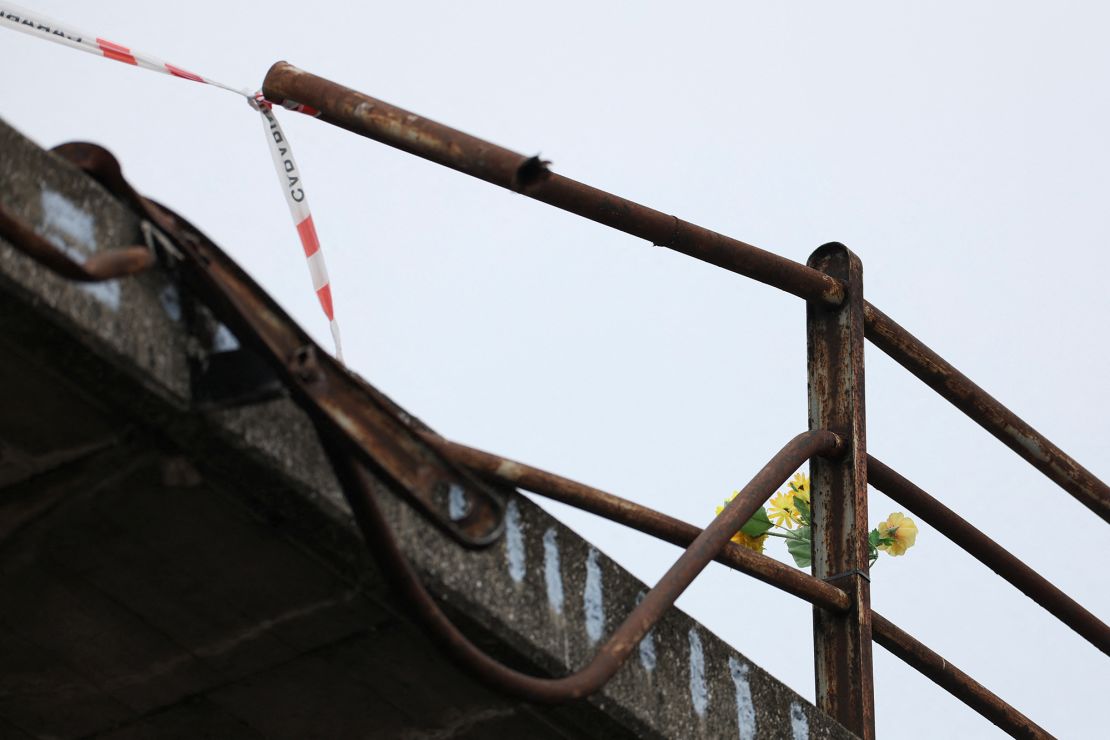 Flowers are seen on Wednesday at the site where a coach crashed off an overpass in Mestre, Italy.