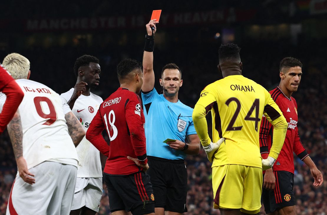 TOPSHOT - Referee Ivan Kruzliak shows a red card to Manchester United's Brazilian midfielder #18 Casemiro during the UEFA Champions league group A football match between Manchester United and Galatasaray at Old Trafford stadium in Manchester, north west England, on October 3, 2023. (Photo by Darren Staples / AFP) (Photo by DARREN STAPLES/AFP via Getty Images)