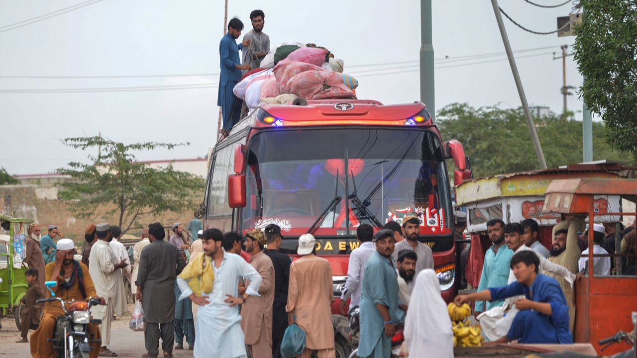 Afghan refugees board a bus from Karachi to Afghanistan on September 21.