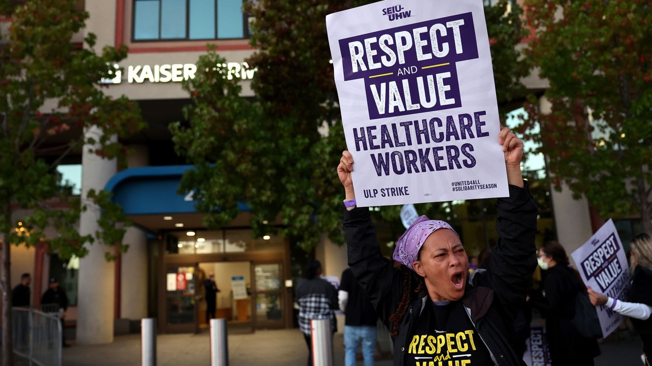 Striking Kaiser Permanente workers hold signs as they march in front of the Kaiser Permanente San Francisco Medical Center on October 04, 2023 in San Francisco, California. More than 75,000 Kaiser Permanente workers went on strike Wednesday morning at hospitals and medical facilities in five states after labor negotiators could not reach an agreement to resolve a staffing level dispute. 