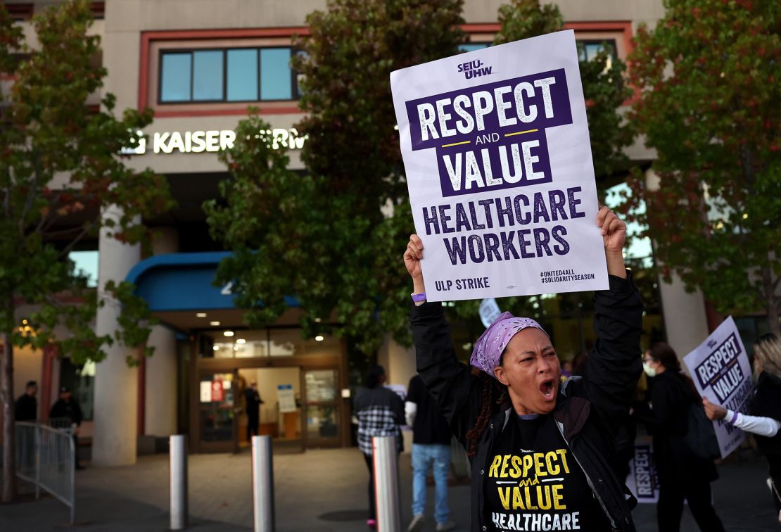 Striking Kaiser Permanente workers hold signs as they march in front of the Kaiser Permanente San Francisco Medical Center on October 04, 2023 in San Francisco, California. More than 75,000 Kaiser Permanente workers went on strike Wednesday morning at hospitals and medical facilities in five states after labor negotiators could not reach an agreement to resolve a staffing level dispute. 
