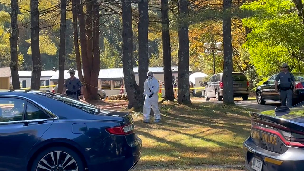 New York State Police and crime scene investigators walk across the property where Charlotte Sena was found.